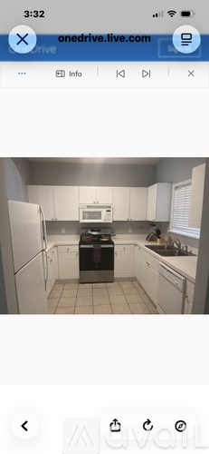 A kitchen with white cabinets and a black stove top.