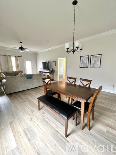 A dining room with a wooden table and bench.