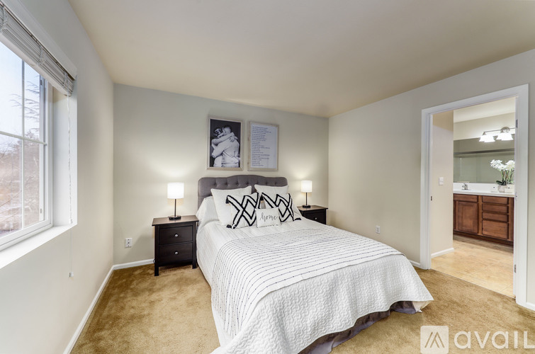 A bedroom with a large bed and a dresser.