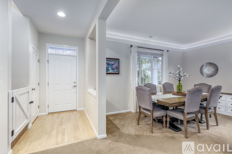 A dining room with a table set for six.