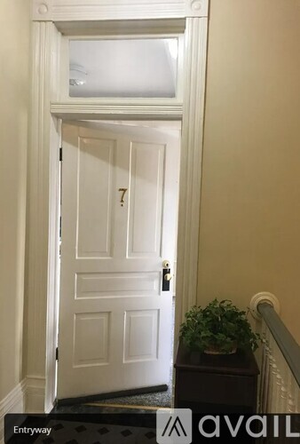 A white door with a black handle and a number 7 on it.