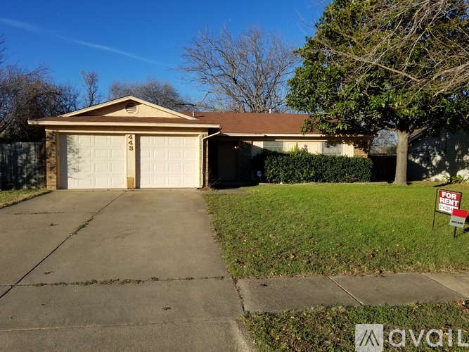 A house with a garage and a sign that says "For Rent".