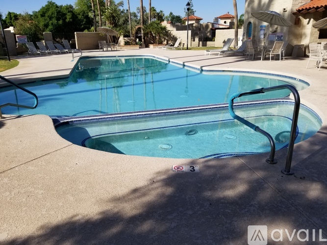 A pool with a ladder and a sun shining on it.