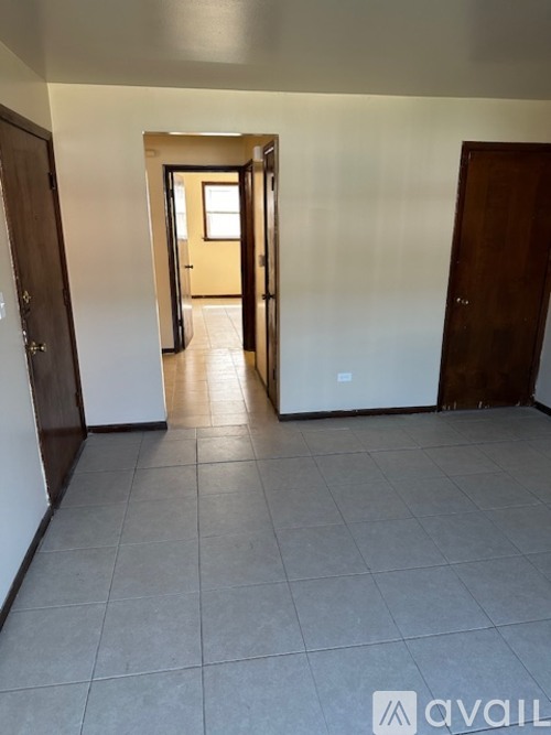 A hallway with a door on the left and a door on the right.