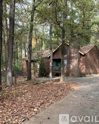 A house surrounded by trees in a wooded area.
