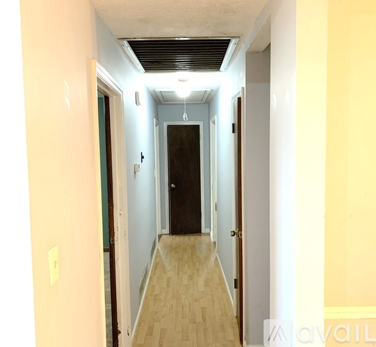 A long hallway with a door at the end.