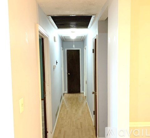 A long hallway with a door at the end.