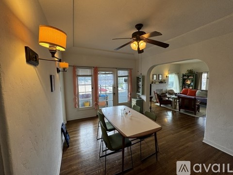 A living room with a dining table and chairs.