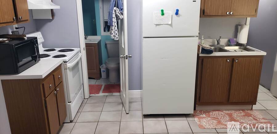 A kitchen with a white refrigerator and a white stove.