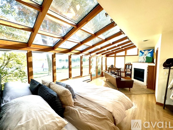 A bedroom with a large bed and a glass roof.