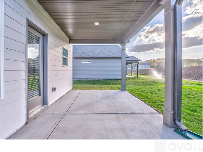A house with a covered walkway leading to a garage.