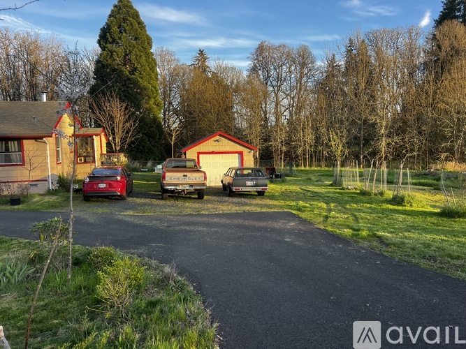 A red car is parked in front of a house.