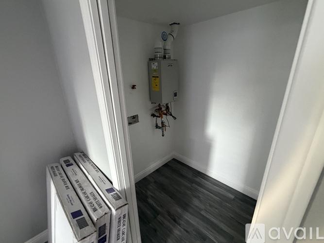 A room with a white wall and a white door with a white frame.