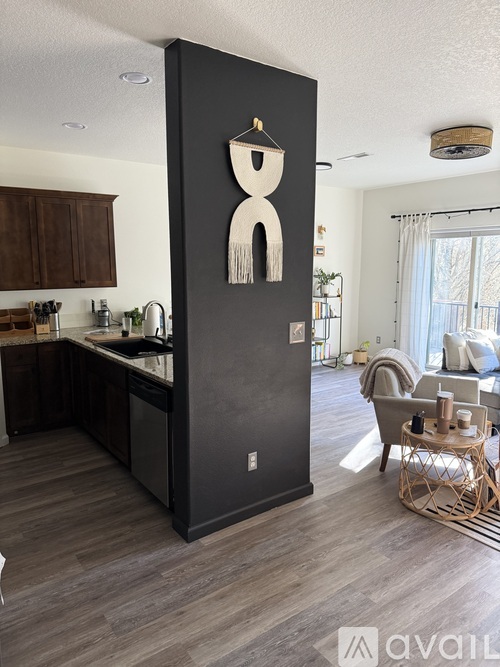 A tall black cabinet with a white framed mirror on top.