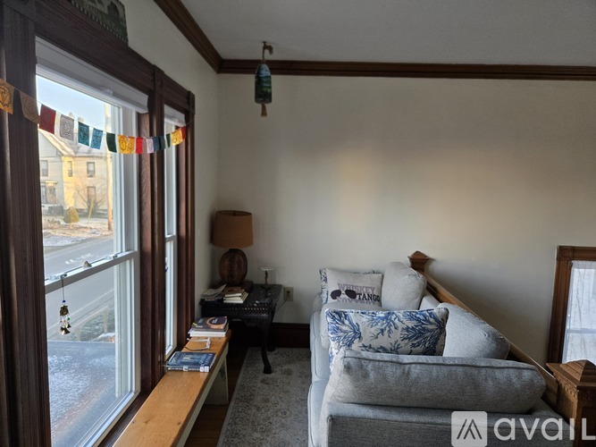 A living room with a grey couch and a wooden table.