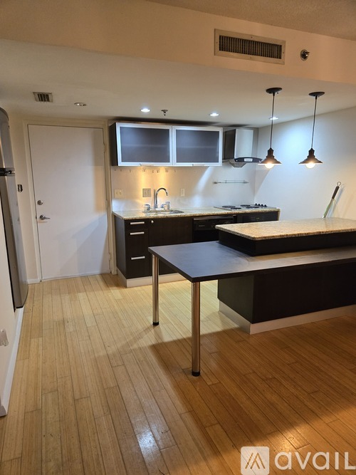 A kitchen with a table and chairs in the middle of it.