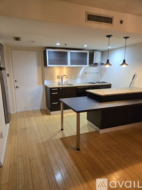 A kitchen with a table and chairs in the middle of it.