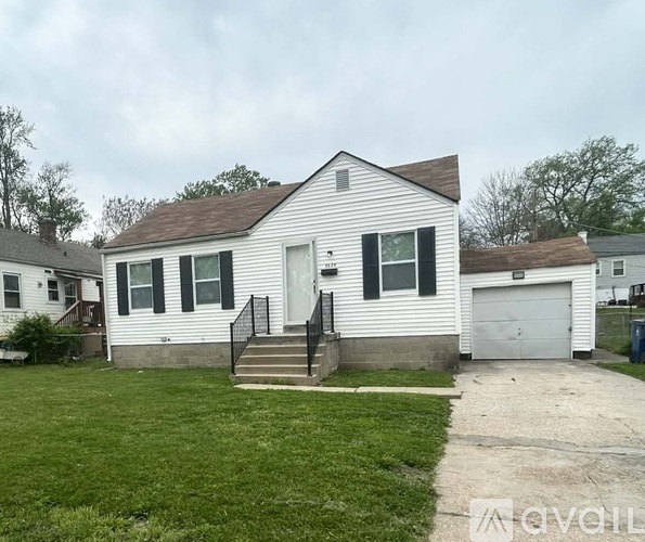 A two-story house with a garage on the right side.