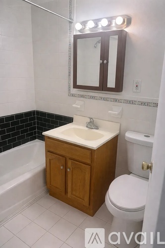 A bathroom with a sink, toilet and tub.