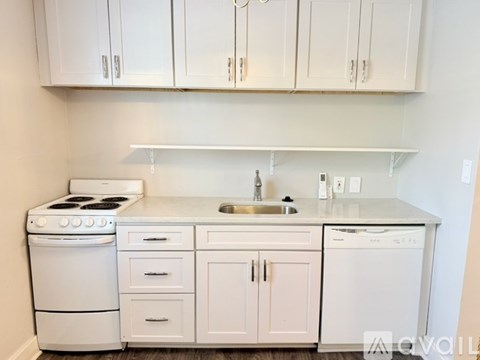 A kitchen with white appliances and cabinets.