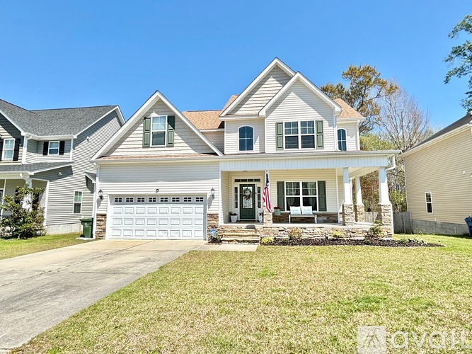 A two-story house with a garage and a front porch.
