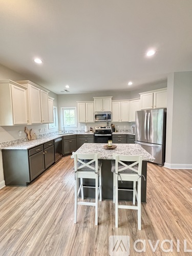 A kitchen with a table and chairs in the middle of the room.