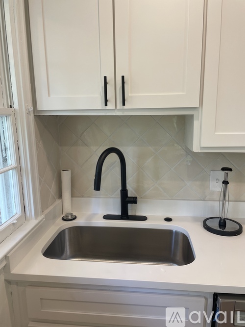 A kitchen with a sink and a window.