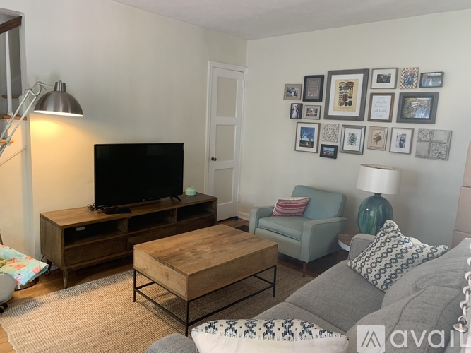 A living room with a television, a couch, and a coffee table.