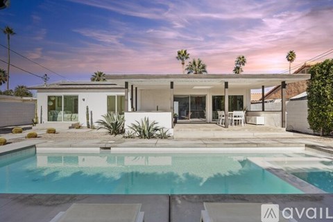 A modern house with a pool in the backyard.