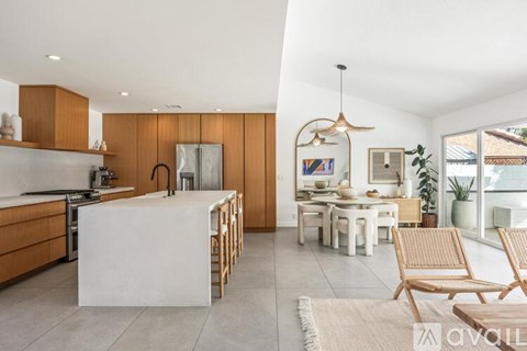 A modern kitchen with wooden cabinets and a white island.