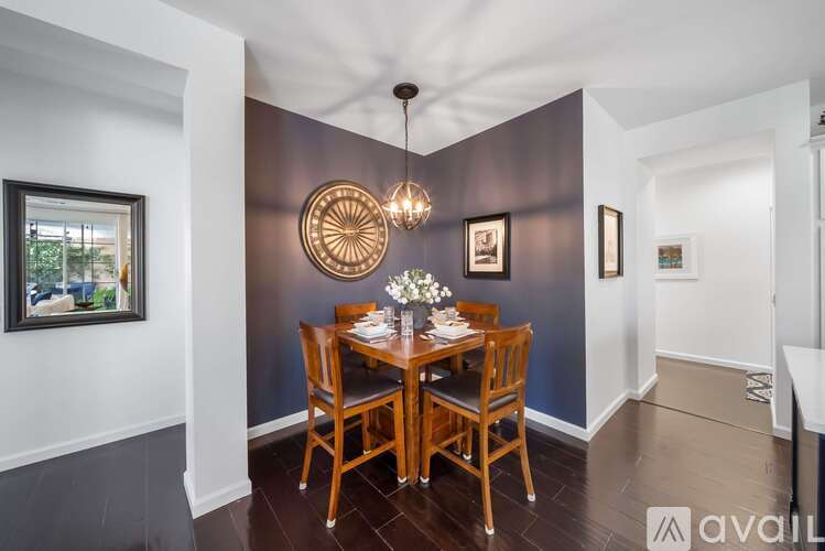A dining room with a wooden table set for two.