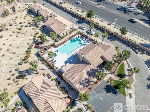 A bird's eye view of a neighborhood with houses and a pool.