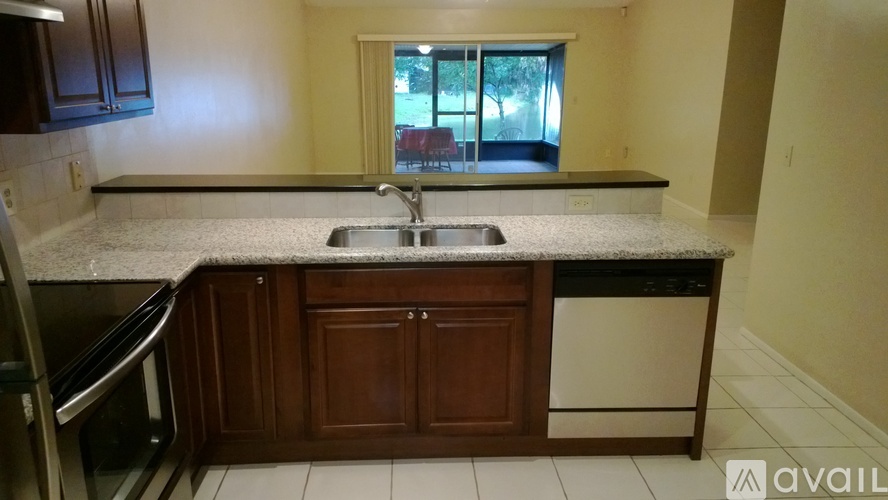A kitchen with a granite countertop and a window.