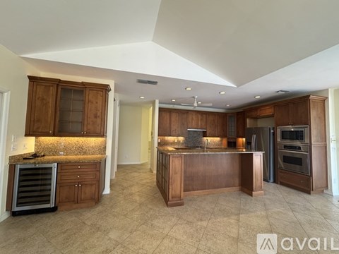 A kitchen with wooden cabinets and a central island.