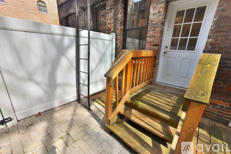 A wooden staircase with a white door in the background.