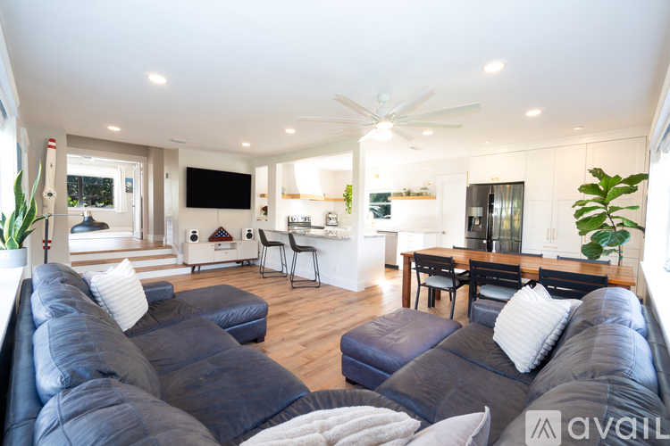 A living room with a large sectional sofa and a television.