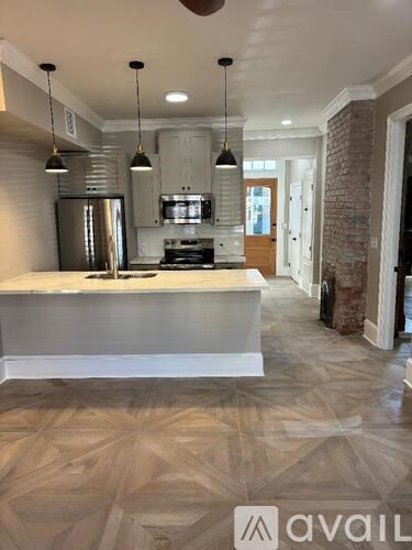 A kitchen with a white countertop and a refrigerator.