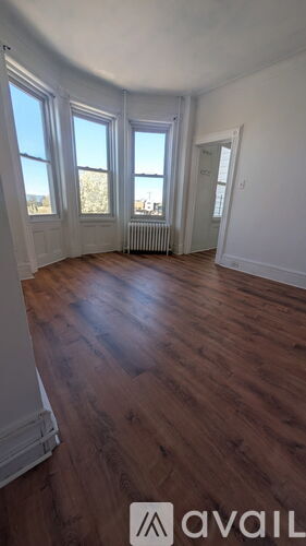 A room with wooden floors and white walls.
