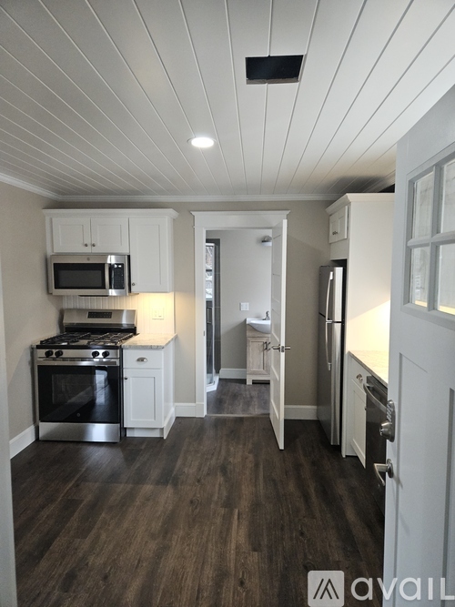 A kitchen with a stove top oven and microwave.