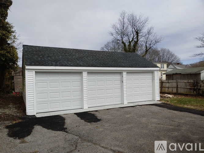 A white garage door is closed and the garage is available for rent.