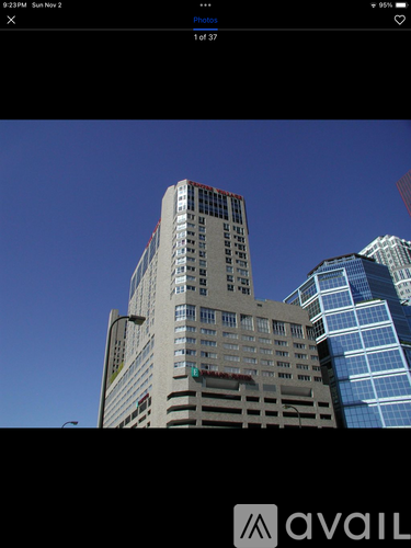 A tall building with a red stripe on the side is in the foreground.
