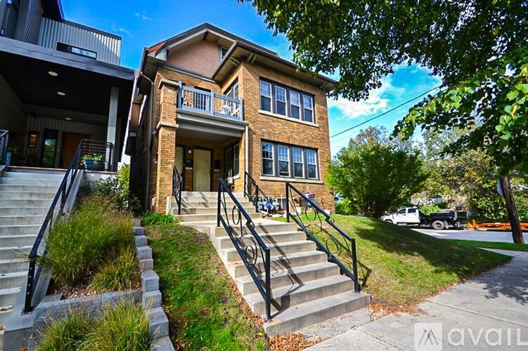 A two-story house with a balcony on the second floor.