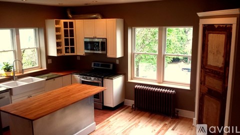 A kitchen with wooden cabinets and a stainless steel island.