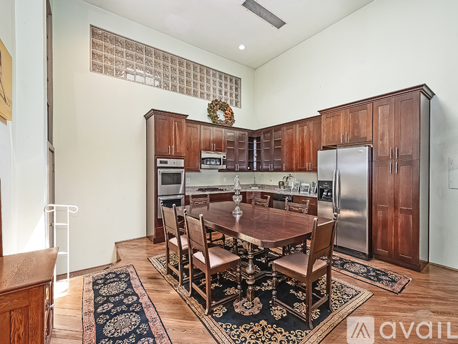 A kitchen with a table and chairs in the middle of the room.