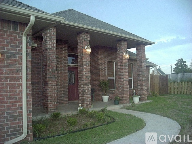 A house with a red door and pillars.