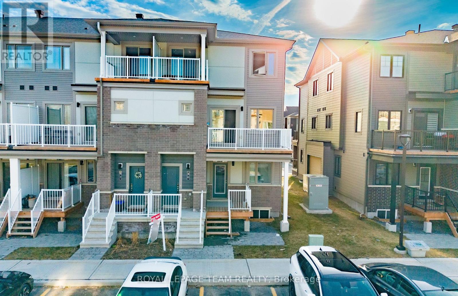 A sunny day at a residential area with cars parked on the street.