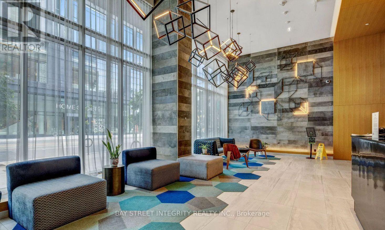 A modern waiting area with a stone pillar and a variety of seating options.