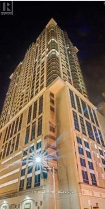 A tall building with a lit up star on the top.