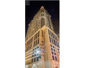 A tall building with a lit up star on the top.