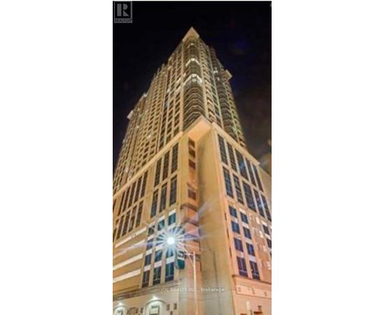 A tall building with a lit up star on the top.